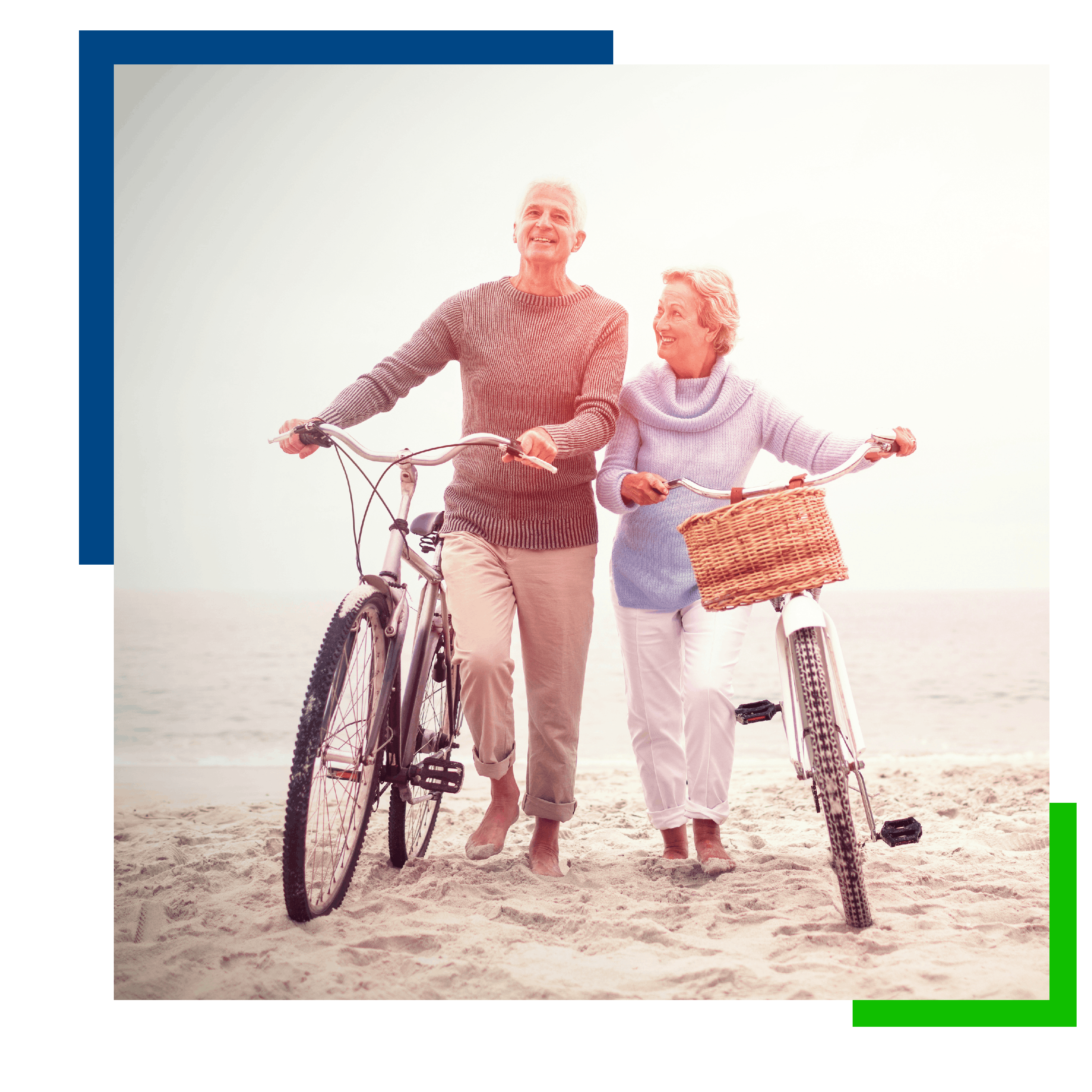 Man and woman holding bicycles on the beach
